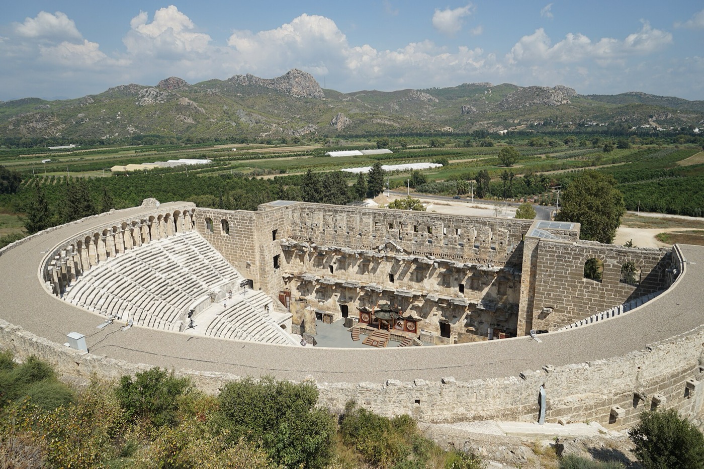 The Aspendos theatre from the slope above, with the Pamphylian plain behind it