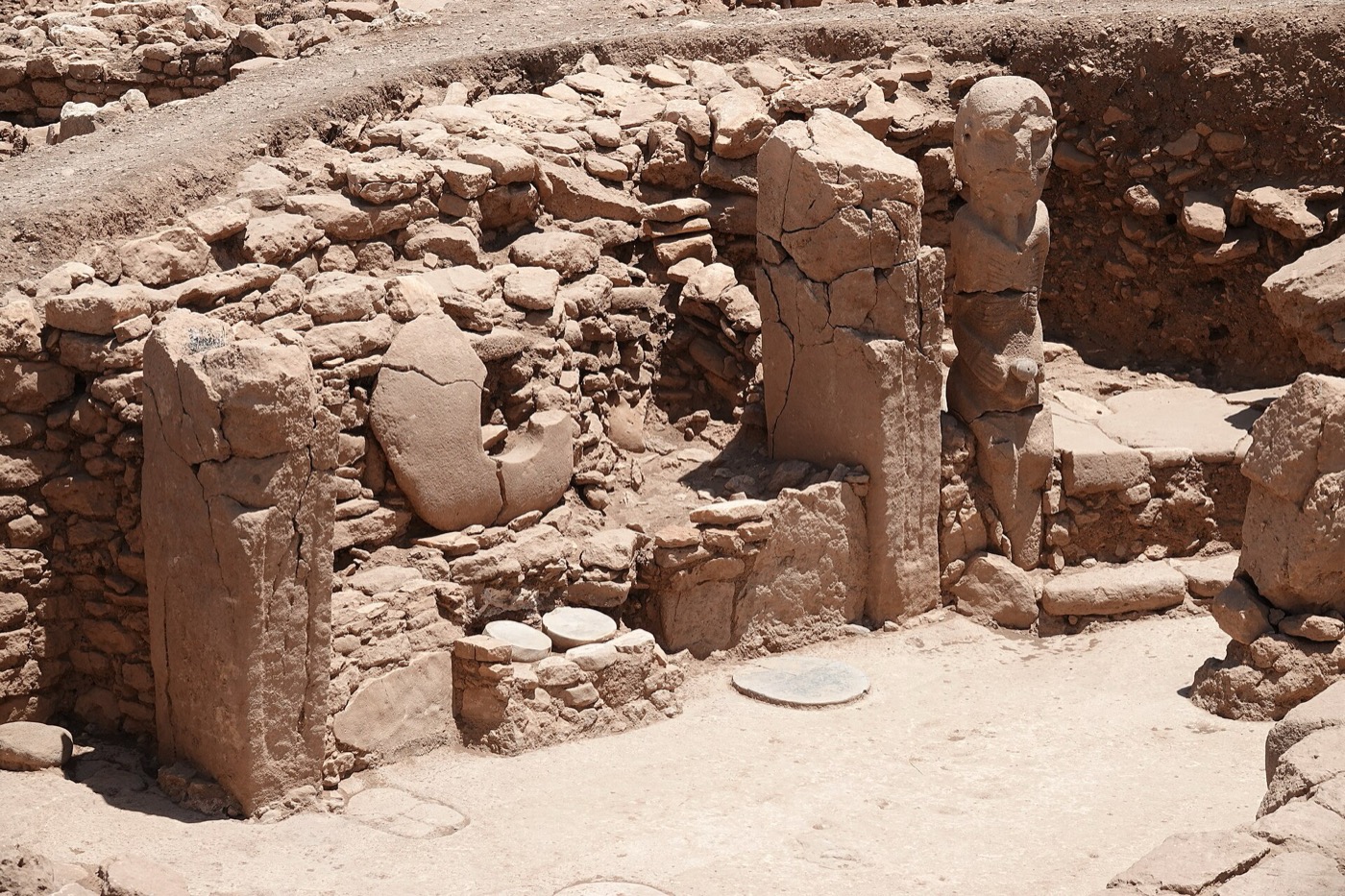 Standing pillars among the excavated walls at Karahantepe