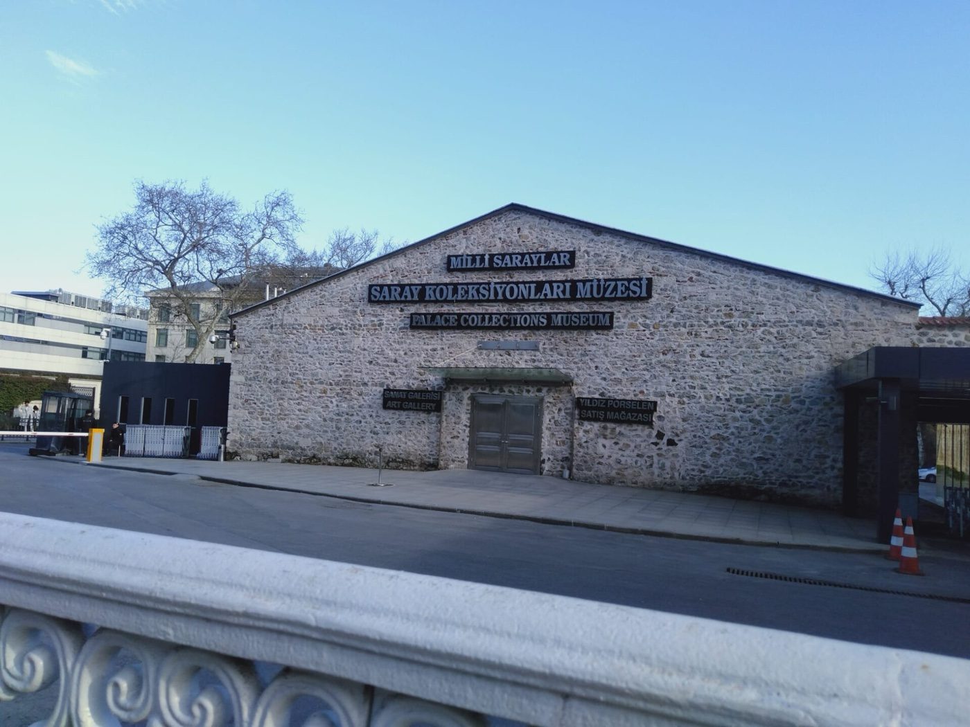 The stone street front of the Palace Collections Museum, the former palace kitchens of Dolmabahçe, with the museum's name in Turkish and English above the door