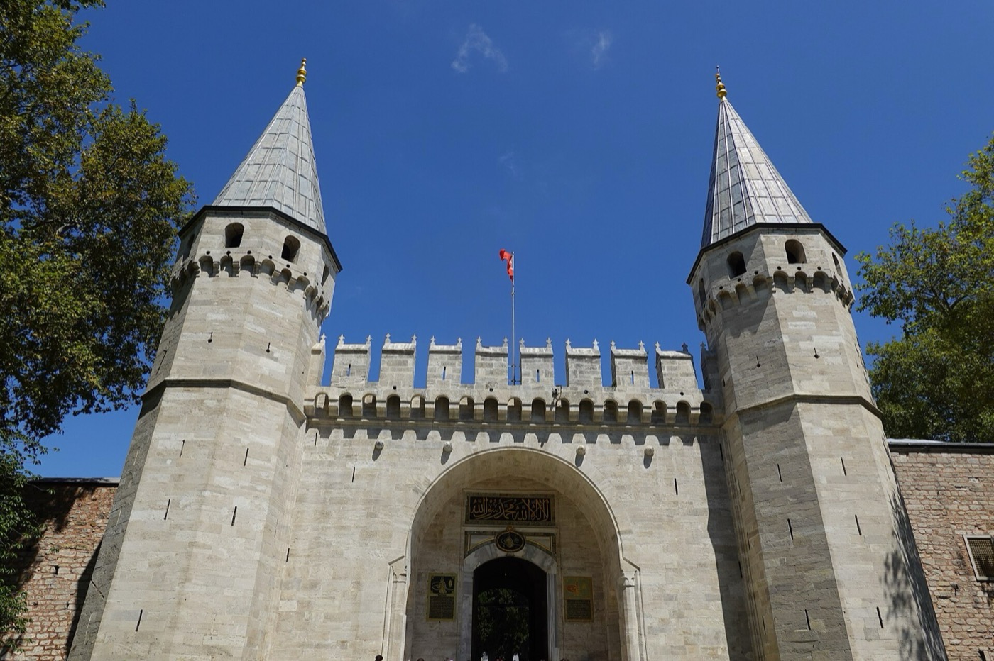 The Gate of Salutation at Topkapı Palace: a stone gateway with battlements between two octagonal towers with pointed conical roofs